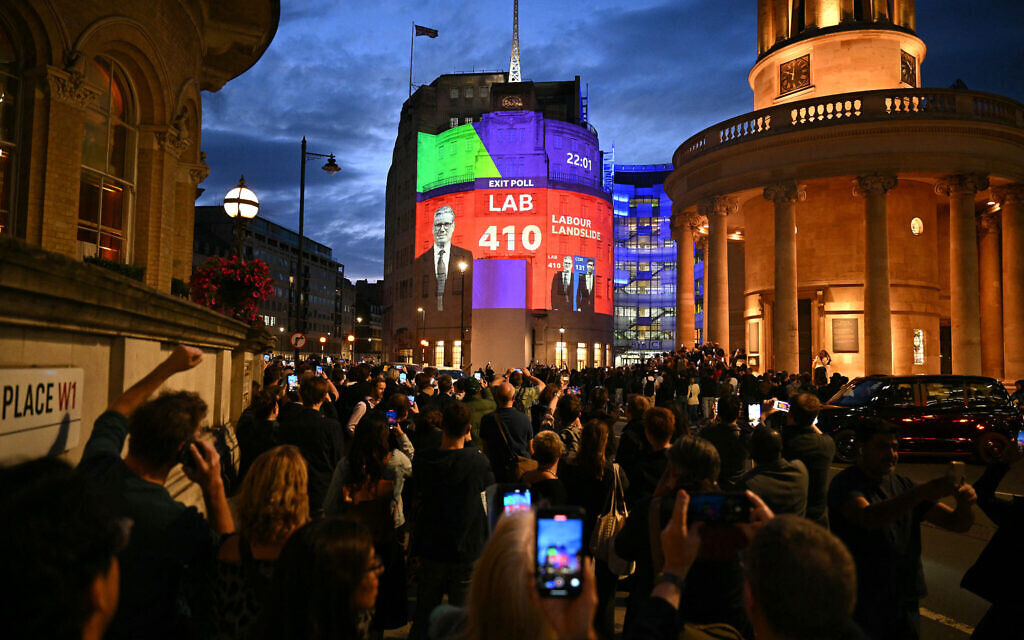 An exit poll predicting that the Labour Party led by Keir Starmer will win 410 seats in Britain's general election is projected onto BBC Broadcasting House in London on July 4, 2024.(Photo by Oli Scarff/ AFP)