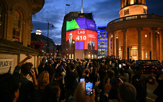 An exit poll predicting that the Labour Party led by Keir Starmer will win 410 seats in Britain's general election is projected onto BBC Broadcasting House in London on July 4, 2024.(Photo by Oli Scarff/ AFP)