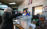 Syrians elect new members of the Parliament in Damascus on July 15, 2024. (Louai Beshara/AFP)