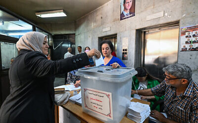 Syrians elect new members of the Parliament in Damascus on July 15, 2024. (Louai Beshara/AFP)
