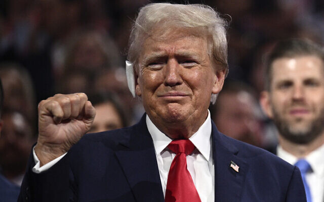 US former president and 2024 Republican presidential candidate Donald Trump, a bandage on his ear after being wounded in an assassination attempt, pumps a fist during the first day of the 2024 Republican National Convention at the Fiserv Forum in Milwaukee, Wisconsin, July 15, 2024. (Brendan SMIALOWSKI / AFP) US former president and 2024 Republican presidential candidate Donald Trump, a bandage on his ear after being wounded in an assassination attempt, pumps a fist during the first day of the 2024 Republican National Convention at the Fiserv Forum in Milwaukee, Wisconsin, July 15, 2024. (Brendan SMIALOWSKI / AFP)