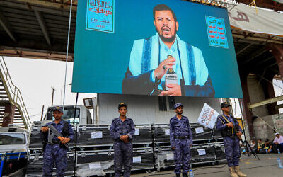 Houthi leader Abdul Malik al-Houthi addresses Shiite Muslims with a speech broadcast on a giant screen during a ceremony commemorating Ashura, in Yemen's Houthi-held capital Sanaa on July 16, 2024. (MOHAMMED HUWAIS / AFP)