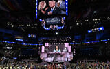 Former US president and 2024 Republican presidential candidate Donald Trump (top, on screen) applauds as US former ambassador to the United Nations and former South Carolina governor Nikki Haley speaks during the second day of the 2024 Republican National Convention at the Fiserv Forum in Milwaukee, Wisconsin, July 16, 2024.(Andrew Caballero-Reynolds/AFP)