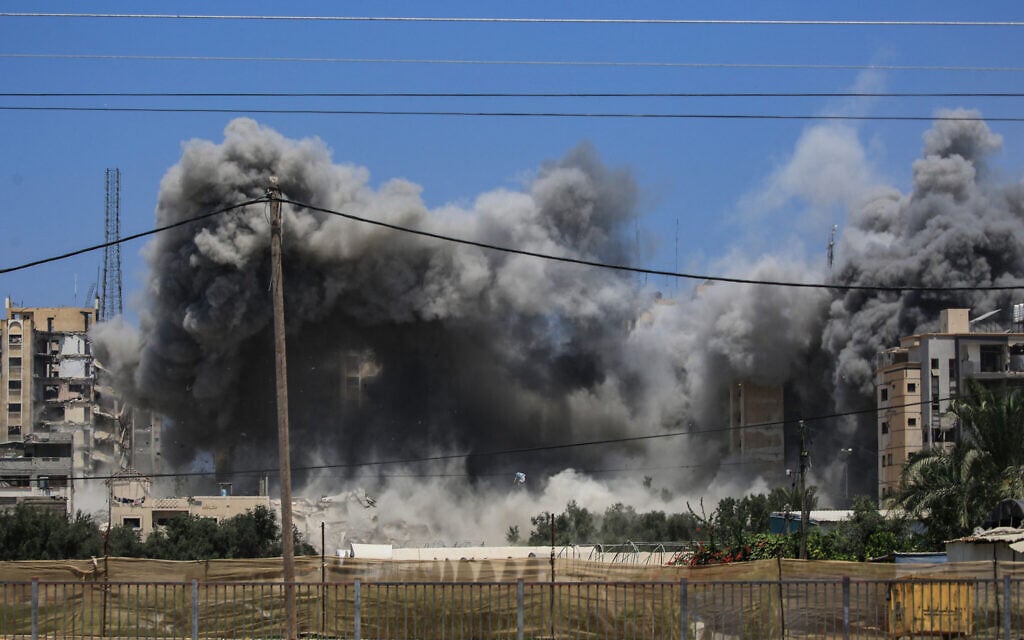Smoke rises from a building hit by an Israeli strike in Nuseirat in the central Gaza Strip on July 20, 2024. (Eyad BABA / AFP)