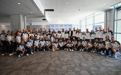 Members of Israel's delegation to the Paris 2024 Olympic and Paralympic Games pose for a group picture ahead of departure, at Ben Gurion airport near Tel Aviv on July 22, 2024. (Jorge Novominsky / AFP)