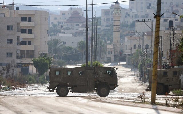 Israeli army armored vehicles during a raid in Tulkarem in the West Bank on July 23, 2024. (JAAFAR ASHTIYEH / AFP) Israeli army armored vehicles during a raid in Tulkarem in the West Bank on July 23, 2024. (JAAFAR ASHTIYEH / AFP)