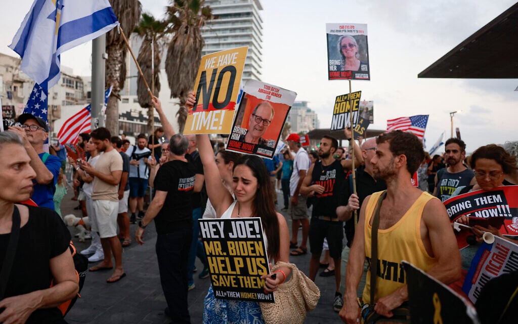 Families and supporters of Israeli hostages protest in front of the US Embassy branch office in Tel Aviv on July 24, 2024. (Menahem Kahana / AFP)
