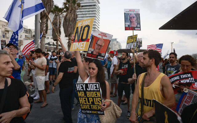 Families and supporters of Israeli hostages protest in front of the US Embassy branch office in Tel Aviv on July 24, 2024. (Menahem Kahana / AFP)