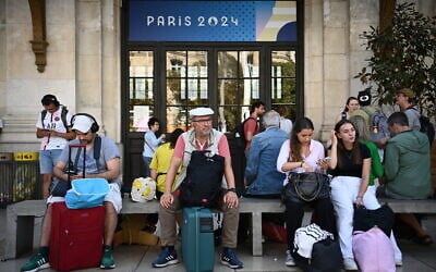 Passengers wait for their train departures at the Bordeaux-Saint-Jean train station in Bordeaux, western France on July 26, 2024, as France's high-speed rail network was hit by an attack disrupting the transport system, hours before the opening ceremony of the Paris 2024 Olympic Games. (Christophe Archambault/AFP)