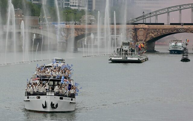 A boat with the delegation from Greece sails in front of a boat with the delegations from Afghanistan, South Africa, Albania, Algeria and Germany during the opening ceremony of the Paris 2024 Olympic Games in Paris on July 26, 2024. (Damien Meyer/AFP) A boat with the delegation from Greece sails in front of a boat with the delegations from Afghanistan, South Africa, Albania, Algeria and Germany during the opening ceremony of the Paris 2024 Olympic Games in Paris on July 26, 2024. (Damien Meyer/AFP)