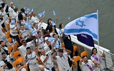 Israel's delegation with Israel's flag bearers Peter Paltchik (2R) and Andrea Murez (R) sails on a boat during the opening ceremony of the Paris 2024 Olympic Games in Paris on July 26, 2024. (Damien Meyer/AFP)