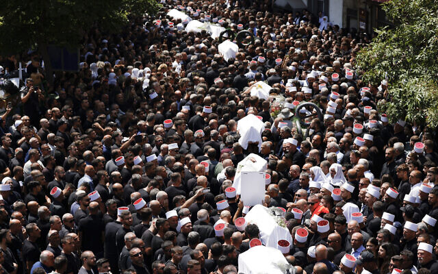 Mourners carry the coffins of 10 of the 12 children killed in a Hezbollah rocket attack in Majdal Shams on July 28, 2024. (Jalaa MAREY / AFP) Mourners carry the coffins of 10 of the 12 children killed in a Hezbollah rocket attack in Majdal Shams on July 28, 2024. (Jalaa MAREY / AFP)