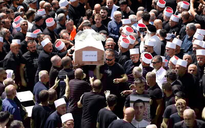 Mourners carry the coffin of a child killed in a Hezbollah rocket strike from Lebanon a day earlier, during a mass funeral in the Druze town of Majdal Shams in the Golan Heights, on July 28, 2024. (Jalaa Marey / AFP)