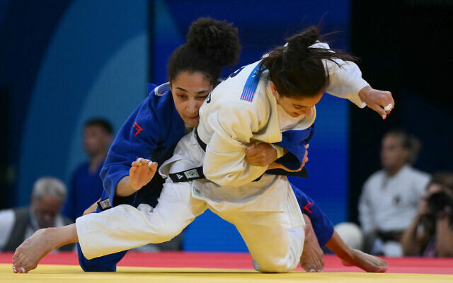 Israel's Gefen Primo and Switzerland's Binta Ndiaye (blue) compete in the judo women's -52kg round of 16 bout of the Paris 2024 Olympic Games at the Champ-de-Mars Arena, July 28, 2024. (Luis ROBAYO / AFP) Israel's Gefen Primo and Switzerland's Binta Ndiaye (blue) compete in the judo women's -52kg round of 16 bout of the Paris 2024 Olympic Games at the Champ-de-Mars Arena, July 28, 2024. (Luis ROBAYO / AFP)