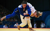 Kosovo's Distria Krasniqi and Israel's Gefen Primo (blue) compete in the judo women's -52kg quarterfinal at the Paris 2024 Olympic Games at the Champ-de-Mars Arena, in Paris, July 28, 2024. (Luis ROBAYO / AFP)