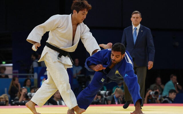 South Korea's Lee Joon-hwan and Israel's Sagi Muki (blue) compete in the judo men's -81kg round of 16 bout at the Paris 2024 Olympic Games at the Champ-de-Mars Arena, in Paris, ,July 30, 2024. (Jack Guez/AFP) South Korea's Lee Joon-hwan and Israel's Sagi Muki (blue) compete in the judo men's -81kg round of 16 bout at the Paris 2024 Olympic Games at the Champ-de-Mars Arena, in Paris, ,July 30, 2024. (Jack Guez/AFP)