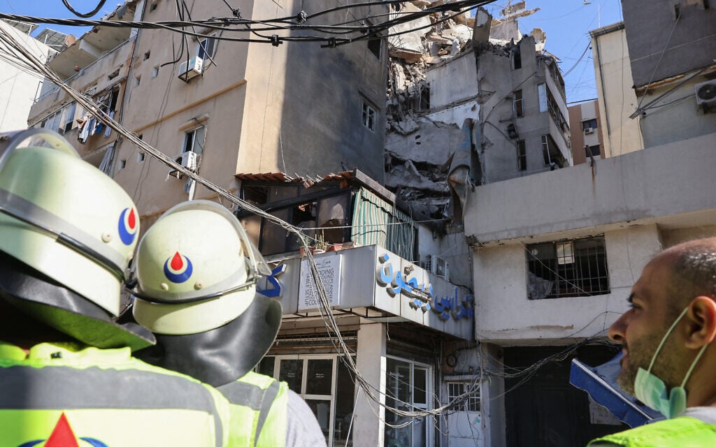 Lebanese civil defense check the area in the aftermath of an Israeli military strike on a building in a southern suburb of Beirut, July 31, 2024. (Anwar Amro / AFP)