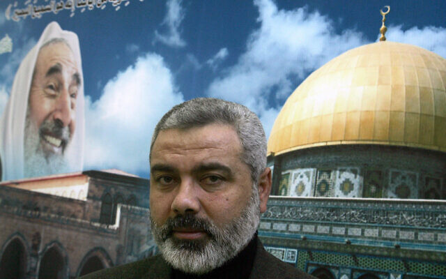 FILE -- Hamas leader Ismail Haniyeh poses for a photograph in front of a mural showing the Dome of the Rock in Jerusalem and an image of assassinated Hamas spiritual leader Sheikh Ahmed Yassin in Gaza City on February 16, 2006.(Photo by AWAD AWAD / AFP) FILE -- Hamas leader Ismail Haniyeh poses for a photograph in front of a mural showing the Dome of the Rock in Jerusalem and an image of assassinated Hamas spiritual leader Sheikh Ahmed Yassin in Gaza City on February 16, 2006.(Photo by AWAD AWAD / AFP)