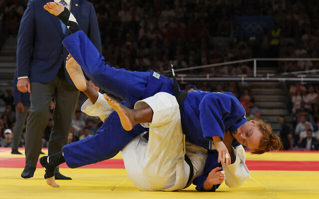 France's Marie Eve Gahie and Israel's Maya Goshen (blue) compete in the judo women's -70kg round of 16 bout of the Paris 2024 Olympic Games at the Champ-de-Mars Arena, in Paris on July 31, 2024. (Jack GUEZ / AFP)