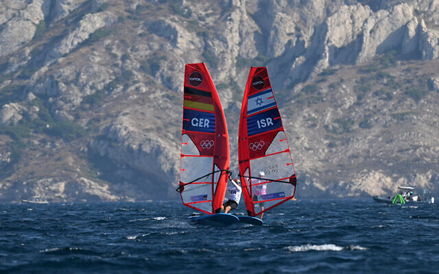 Germany's Sebastian Koerdel and Israel's Tom Reuveny compete in race 9 of the men's IQFoil windsurfing event during the Paris 2024 Olympic Games in Marseille on July 31, 2024. (NICOLAS TUCAT / AFP)