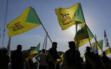 Fighters from the Popular Mobilization Forces attend the funeral of a commander from the Kataib Hezbollah paramilitary group killed in a US airstrike, in Baghdad, Iraq on February 8, 2024. (AP/Hadi Mizban, File)