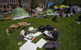 Anti-Israel protesters make signs in an encampment area on the University of Wisconsin-Milwaukee campus, April 30, 2024, in Milwaukee. (AP Photo/Morry Gash)