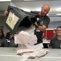Boxes of votes are emptied ready to be counted for the British Parliamentary constituency of Holborn and St Pancras where the Labour Party leader Keir Starmer is standing for election, in London, July 4, 2024. (AP Photo/Kin Cheung)