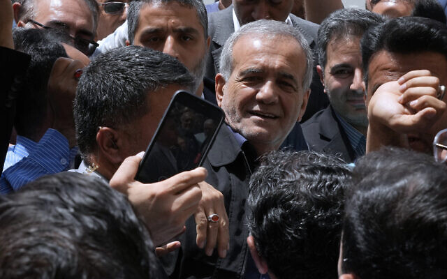 Reformist candidate for the Iran's presidential election Masoud Pezeshkian is greeted by his supporters as he arrives to vote at a polling station in Shahr-e-Qods near Tehran, Iran, July 5, 2024. (AP Photo/Vahid Salemi) Reformist candidate for the Iran's presidential election Masoud Pezeshkian is greeted by his supporters as he arrives to vote at a polling station in Shahr-e-Qods near Tehran, Iran, July 5, 2024. (AP Photo/Vahid Salemi)