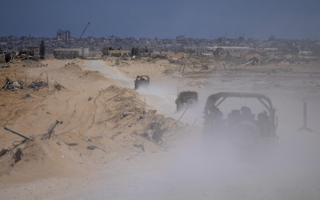 IDF vehicles transport a group of soldiers and journalists inside the southern Gaza Strip, July 3, 2024. (AP Photo/ Ohad Zwigenberg, Pool) IDF vehicles transport a group of soldiers and journalists inside the southern Gaza Strip, July 3, 2024. (AP Photo/ Ohad Zwigenberg, Pool)