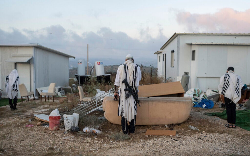 Right-wing activists pray in the illegal Evyatar outpost in the West Bank, July 7, 2024 (AP Photo/Ohad Zwigenberg)