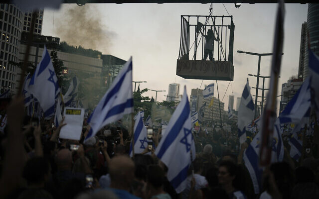 Einav Zangauker, the mother of hostage Matan Zangauker, stands in a cage during a demonstration calling for a hostage release deal, outside the IDF's headquarters in Tel Aviv on July 7, 2024. (AP Photo/Leo Correa) Einav Zangauker, the mother of hostage Matan Zangauker, stands in a cage during a demonstration calling for a hostage release deal, outside the IDF's headquarters in Tel Aviv on July 7, 2024. (AP Photo/Leo Correa)
