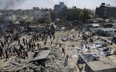 Palestinians inspect the damage at a site hit by an Israeli operation targeting Hamas's shadowy military commander Mohammad Deif in Khan Younis, southern Gaza Strip, July 13, 2024. (AP Photo/Jehad Alshrafi)