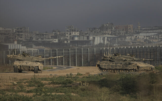 Israeli tanks stand near the Israel-Gaza border as seen from southern Israel, July 14, 2024. (AP Photo/Tsafrir Abayov) Israeli tanks stand near the Israel-Gaza border as seen from southern Israel, July 14, 2024. (AP Photo/Tsafrir Abayov)
