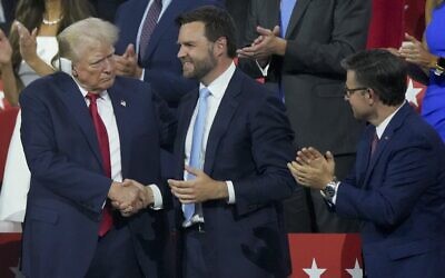 Republican US presidential candidate former president Donald Trump, left, shakes hands with Republican vice presidential candidate Senator JD Vance during the Republican National Convention, July 15, 2024, in Milwaukee. (AP Photo/Matt Rourke)