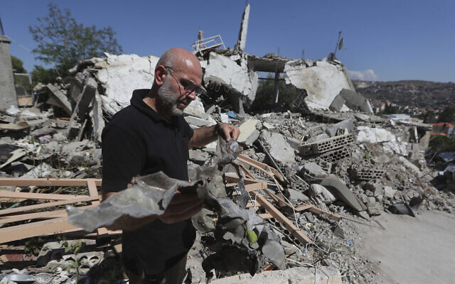A man shows the remain of an Israeli missile that hit a house and killed a Hezbollah fighter with two of his civilian family members, in Bint Jbeil town, south Lebanon, Tuesday, July 16, 2024. (AP Photo/Mohammed Zaatari) A man shows the remain of an Israeli missile that hit a house and killed a Hezbollah fighter with two of his civilian family members, in Bint Jbeil town, south Lebanon, Tuesday, July 16, 2024. (AP Photo/Mohammed Zaatari)