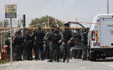 Illustrative: Israeli Police investigate an attempted stabbing attack at the entrance to Netiv Ha'asara, north of the Gaza border in southern Israel, July 22, 2024. (AP Photo/Tsafrir Abayov)