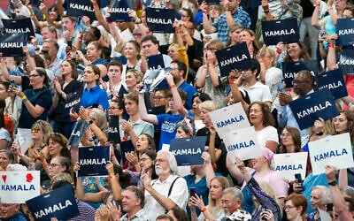Supports hold up signs backing US Vice President Kamala Harris as she campaigns for resident as the presumptive Democratic candidate during an event at West Allis Central High School, July 23, 2024, in West Allis, Wisconsin. (Kayla Wolf/Ap)