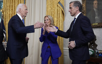 US President Joe Biden, left, greets his son Hunter Biden after addressing Americans from the Oval Office of the White House in Washington, July 24, 2024, about his decision to drop his Democratic presidential reelection bid, as first lady Jill Biden watches. (AP Photo/Evan Vucci, Pool)