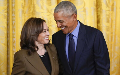 Former US President Barack Obama talks with US Vice President Kamala Harris during an event about the Affordable Care Act, in the East Room of the White House in Washington, April 5, 2022. (AP Photo/Carolyn Kaster, File)