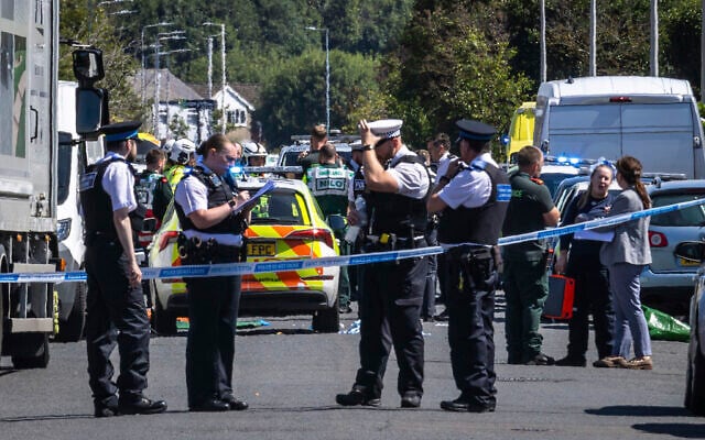 Police secure the area where a man was detained and a knife seized after a deadly stabbing, in Southport, Merseyside, England, Monday July 29, 2024. (James Speakman/PA via AP) Police secure the area where a man was detained and a knife seized after a deadly stabbing, in Southport, Merseyside, England, Monday July 29, 2024. (James Speakman/PA via AP)