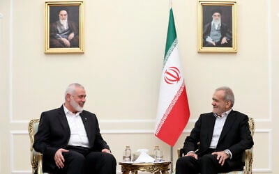 Iran's newly sworn-in president Masoud Pezeshkian, right, meets Hamas political chief Ismail Haniyeh, at the President's office in Tehran, Iran, July 30, 2024. (Iranian Presidency Office via AP)
