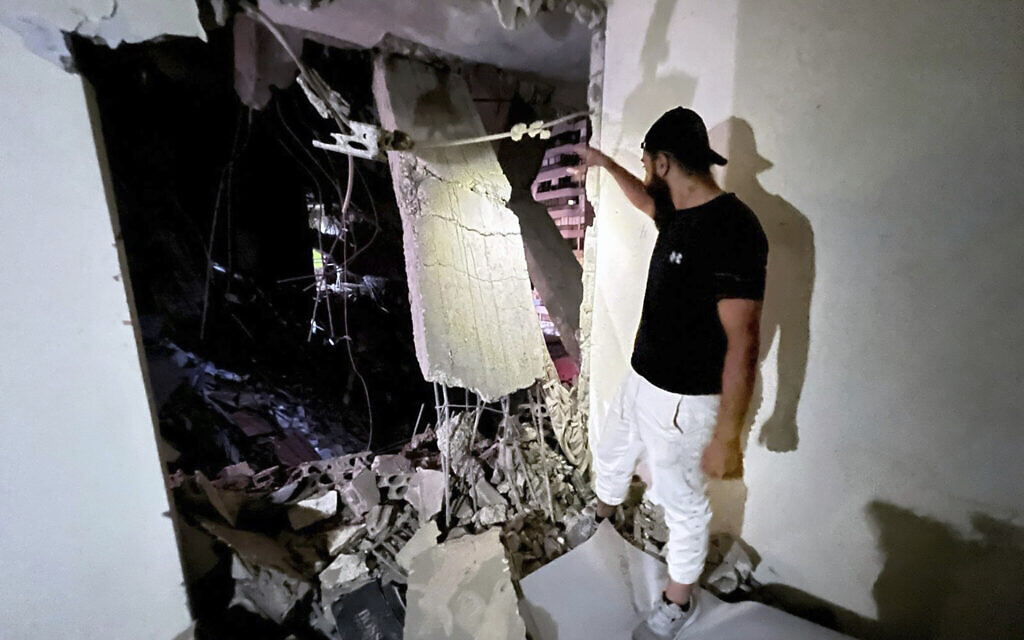 A man inspects damage following an Israeli airstrike in the southern suburbs of Beirut, Lebanon, Tuesday, July 30, 2024. (AP/Hussein Malla)