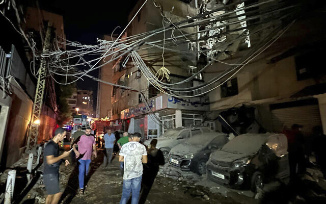 People gather near a destroyed building that was hit by an Israeli airstrike in the southern suburbs of Beirut, Lebanon, Tuesday, July 30, 2024. (AP Photo/Hussein Malla) People gather near a destroyed building that was hit by an Israeli airstrike in the southern suburbs of Beirut, Lebanon, Tuesday, July 30, 2024. (AP Photo/Hussein Malla)