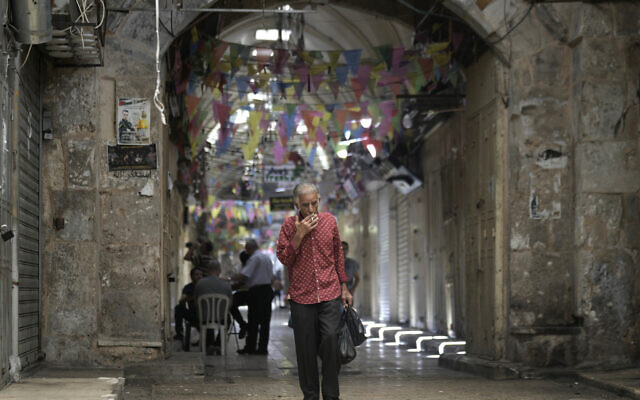 A Palestinian man walks through the West Bank city of Nablus, where shops are closed as part of a general strike following the assassination of Hamas leader Ismail Haniyeh, Wednesday, July 31, 2024. (AP Photo/Majdi Mohammed)