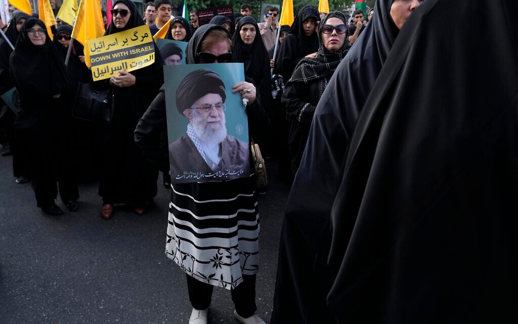 Iranian protesters hold a poster of Supreme Leader Ayatollah Ali Khamenei and an anti-Israel placard in a demonstration to condemn the killing of Hamas leader Ismail Haniyeh, at Felestin (Palestine) Square in Tehran, Iran, July 31, 2024. (AP Photo/Vahid Salemi)