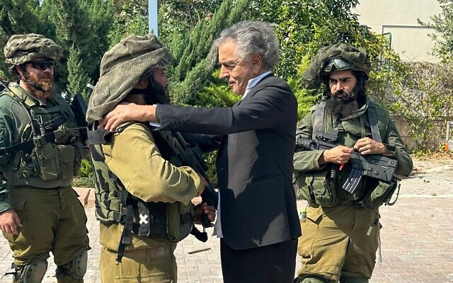 Bernard-Henri Levy, center, in Kibbutz Kfar Aza, October 11, 2023. (Benjamin Touati)