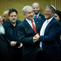 Prime Minister Benjamin Netanyahu, center, embraces National Security Minister Itamar Ben Gvir as ministers attend a meeting on the planned state budget, in the Knesset in Jerusalem, May 23, 2023. (Yonatan Sindel/Flash90)
