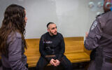 Adi Mizrahi, who stabbed Yuri Volkov to death in 2022 in Holon, arrives for a court hearing at the Tel Aviv District Court on January 29, 2024. (Flash90)