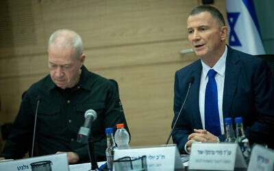 Defense Minister Yoav Gallant (right) and committee chair Yuli Edelstein attend a Foreign Affairs and Defense Committee meeting on the ultra-Orthodox draft law at the Knesset, in Jerusalem, on July 1, 2024. (Yonatan Sindel/Flash90)
