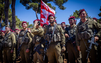 Israeli soldiers attend a swearing-in ceremony as they enter the Paratroopers Brigade, at the Ammunition Hill Heritage Site in Jerusalem, July 3, 2024. (Chaim Goldberg/Flash90)